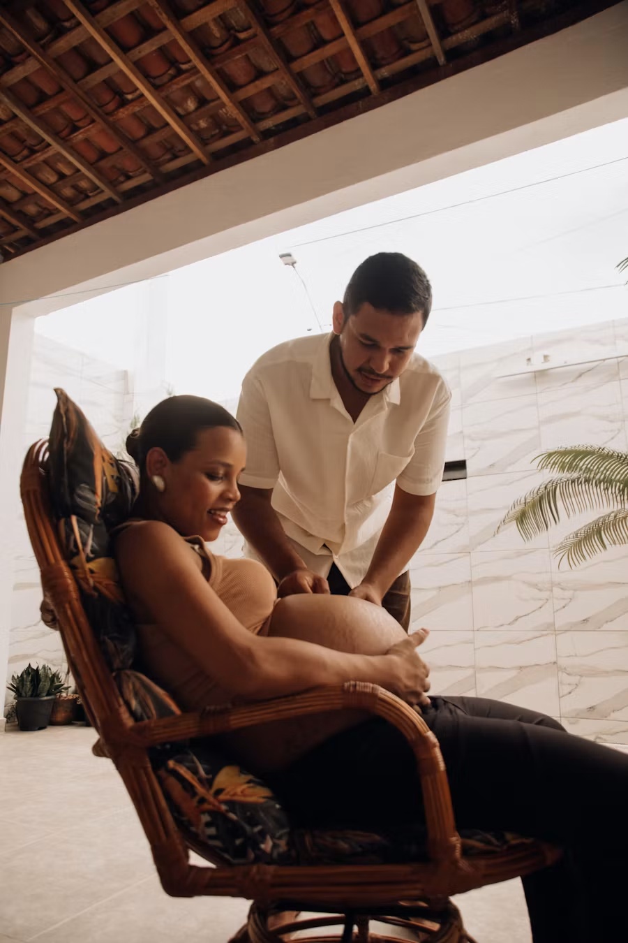 Pregnant client receiving supportive prenatal bodywork during a wellness session